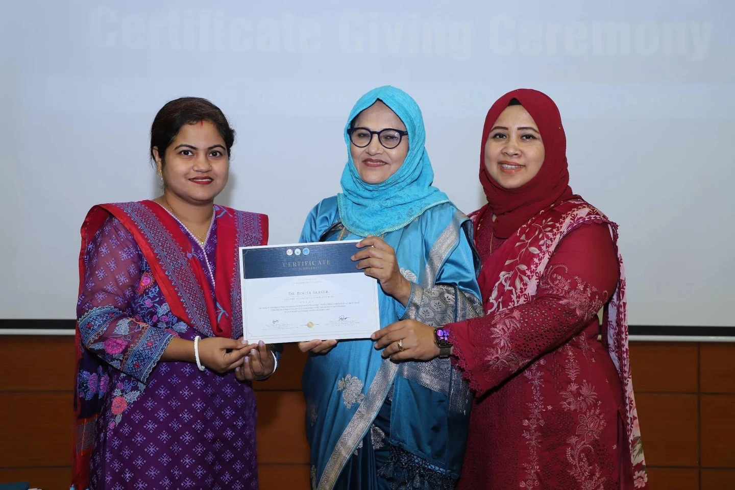 Dr. Binita Sarker Shanta at a certificate presentation with two other women